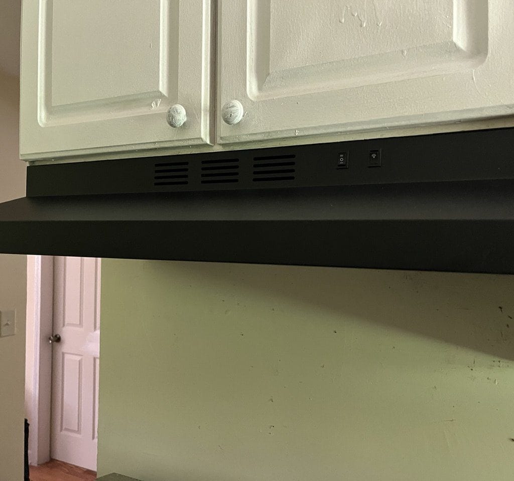 Black kitchen range hood mounted