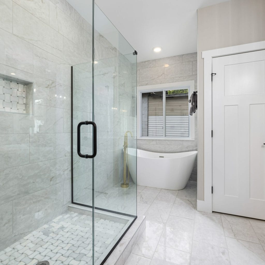 Fixing shower doors in Charlotte—frameless glass door repair by Busy Beaver Handyman Services.