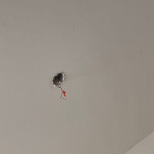 Before professional ceiling fan installation: preparing the electrical box and wiring in a Charlotte home.