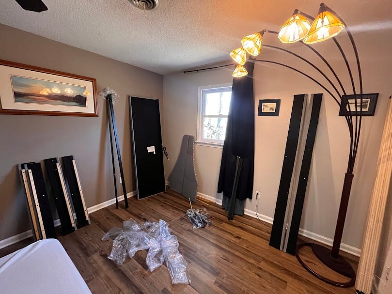 A residential room in Waxhaw, NC being prepared for large-scale furniture assembly and professional furniture painting services.