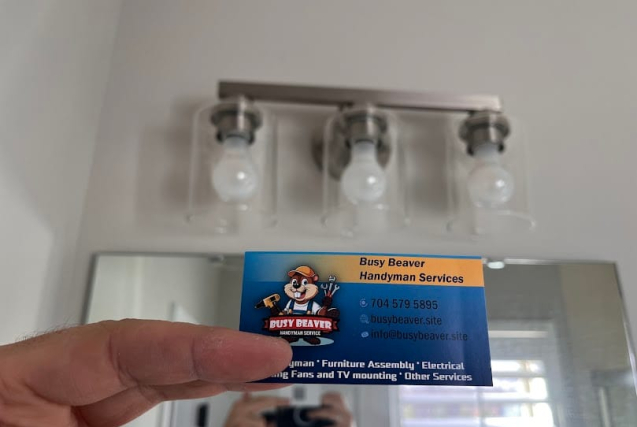 Local handyman from Busy Beaver Handyman Services performing electrical repair in a Charlotte NC home, replacing a wall switch