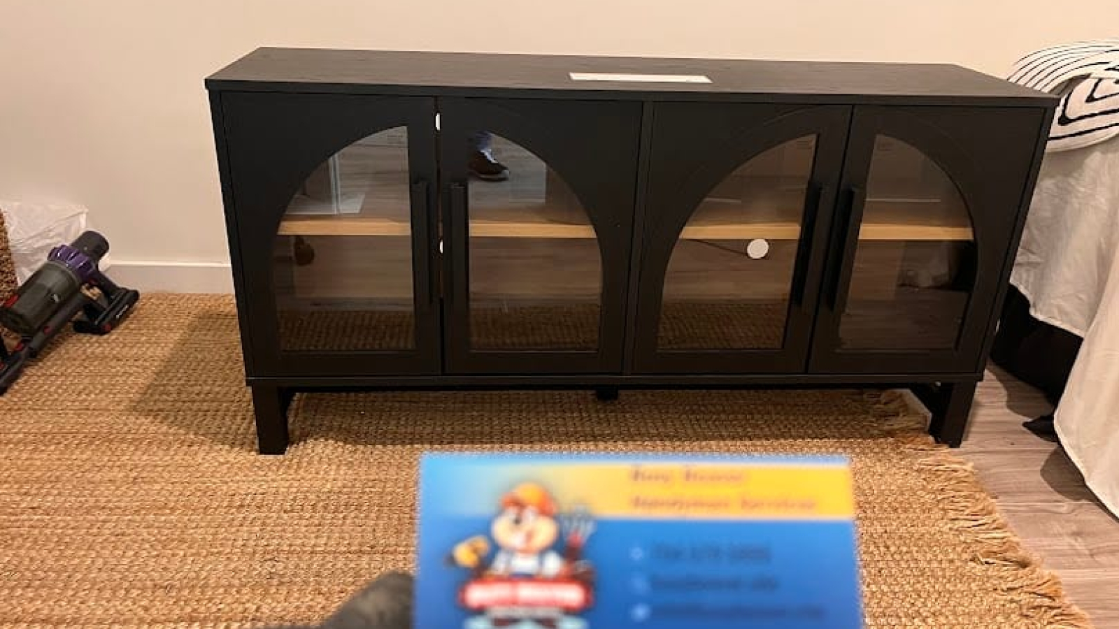 A sleek black IKEA-style sideboard with arched glass doors, assembled by Busy Beaver Handyman Services for a client in Waxhaw, NC.