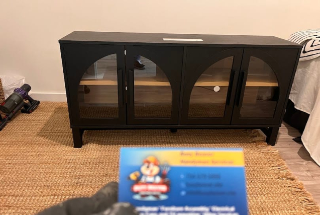 A sleek black IKEA-style sideboard with arched glass doors, assembled by Busy Beaver Handyman Services for a client in Waxhaw, NC.