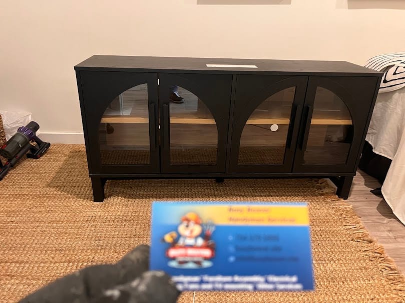 A sleek black IKEA-style sideboard with arched glass doors, assembled by Busy Beaver Handyman Services for a client in Waxhaw, NC.