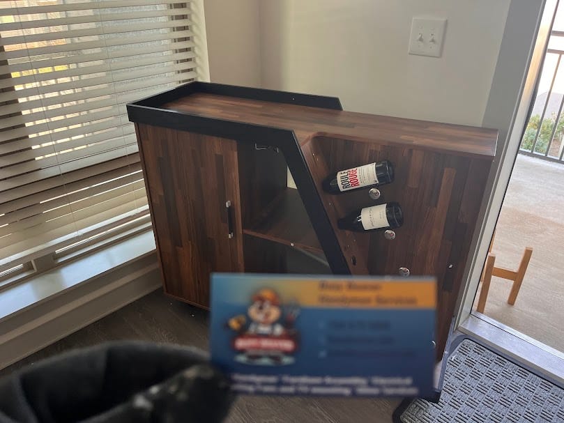 A professionally assembled wooden wine bar cabinet featuring built-in racks, completed by an expert IKEA furniture assembly company in Charlotte, NC.