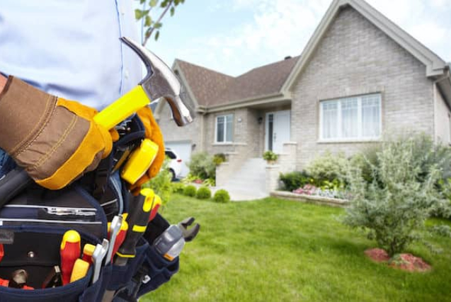Handyman with tools outside a house