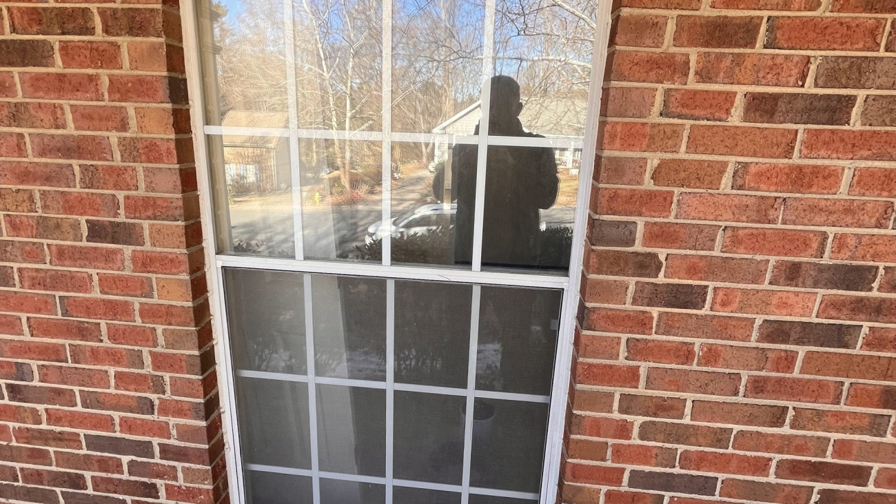 window installation with brick wall background